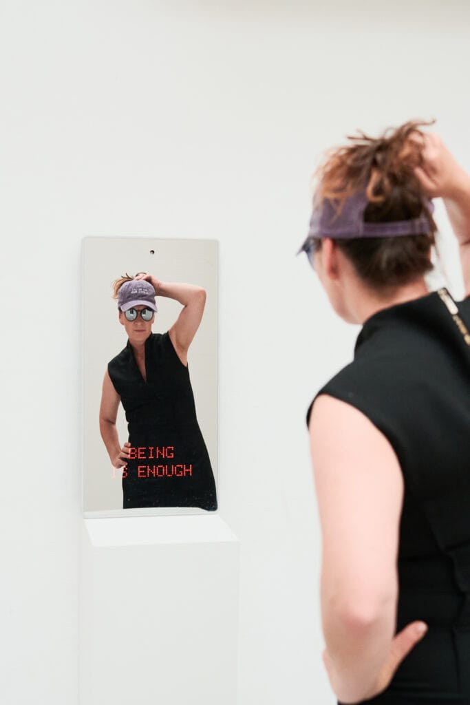 Marie Lienhard in front of her artwork